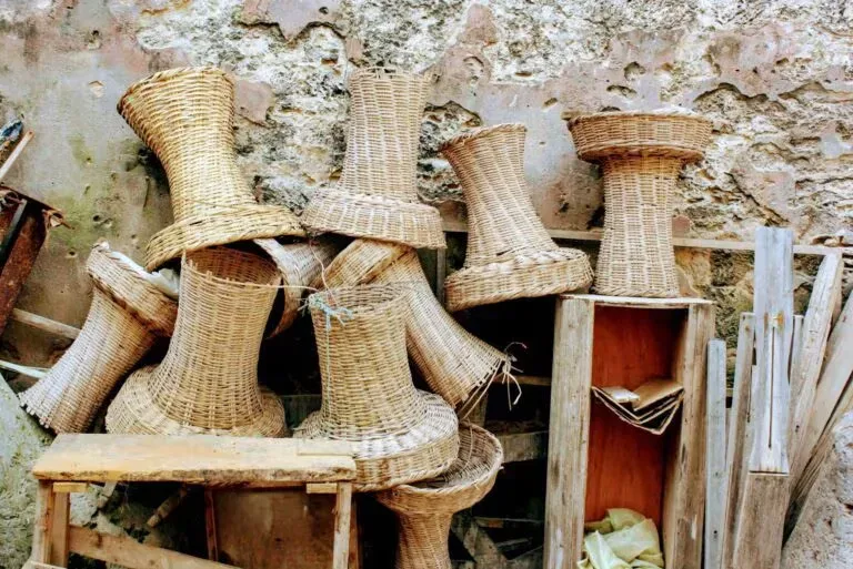 A Ugandan artisan weaving a traditional basket